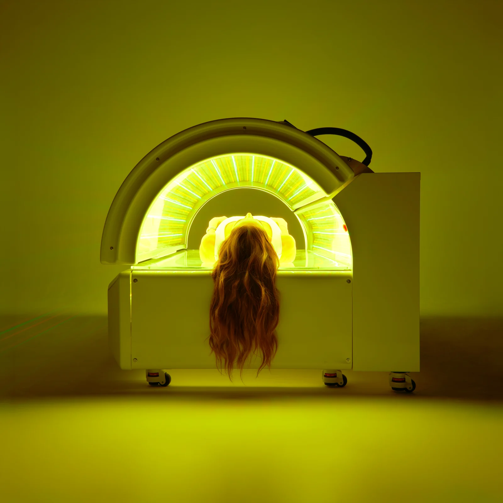 A customer lying inside the green-lit Soluxia bed