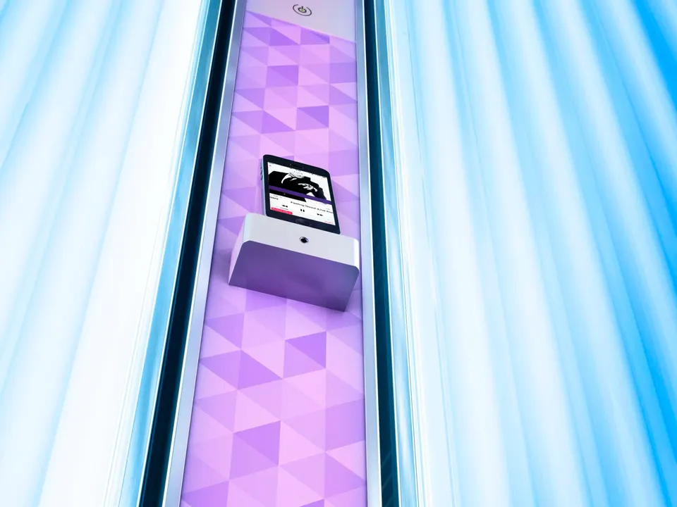 Lit tubes either side of the V6's violet FlowLight column, a phone resting in its holder