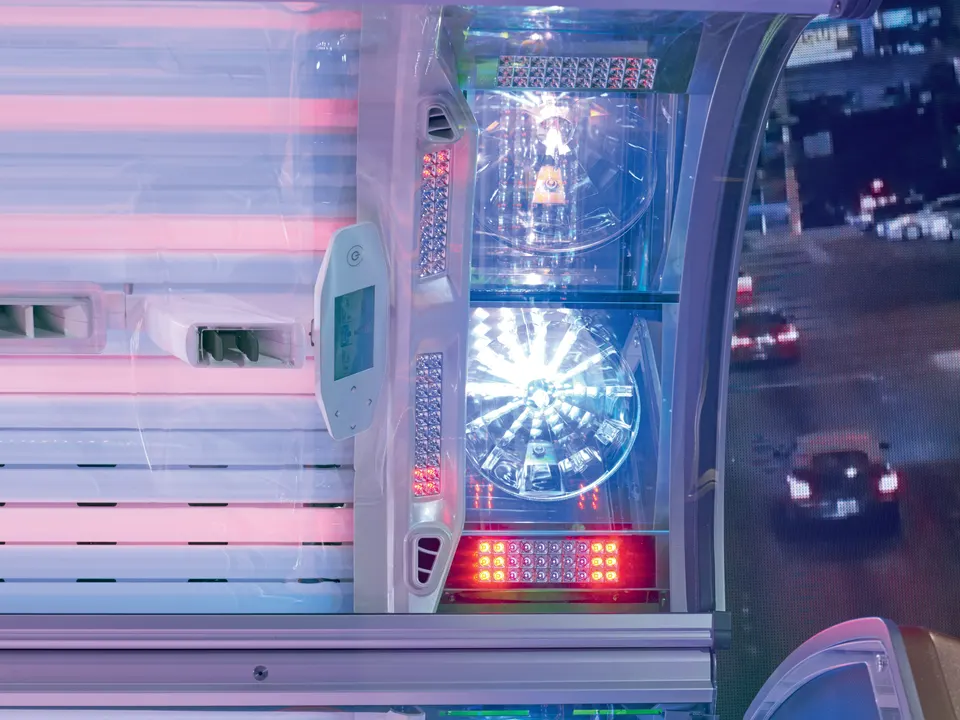 Face tanners in a Vegaz canopy, with LED arrays beside and below them and red and blue tubes to the left