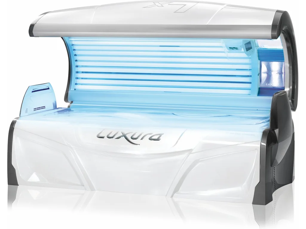 The Luxura X7 Special open, with its tubes lit blue in the bench and canopy and the facial tanners at the head end
