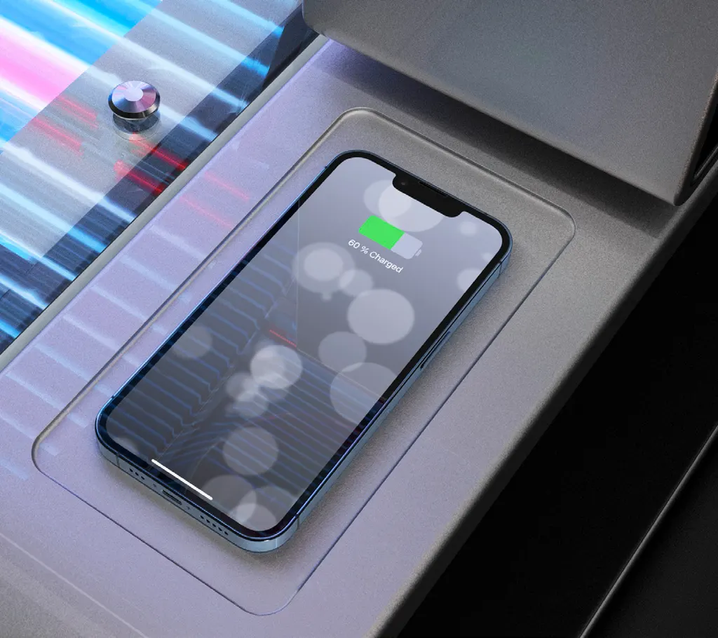 A phone lying in the wireless charging mould beside the bed's acrylic