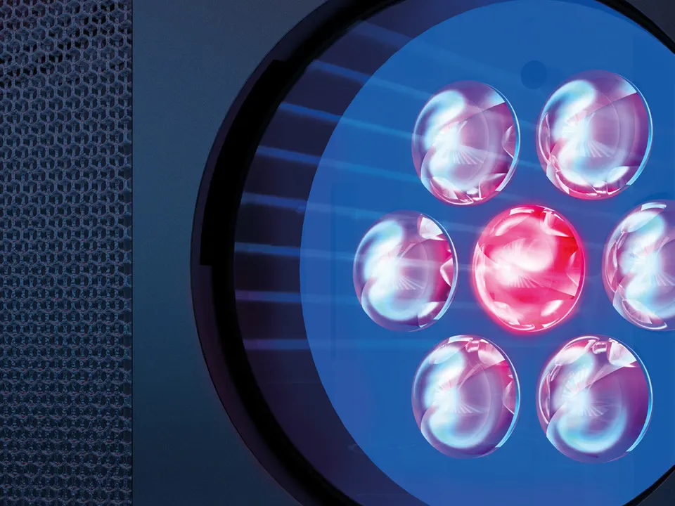 A SunSphere shoulder tanner, LEDs glowing behind a round lens