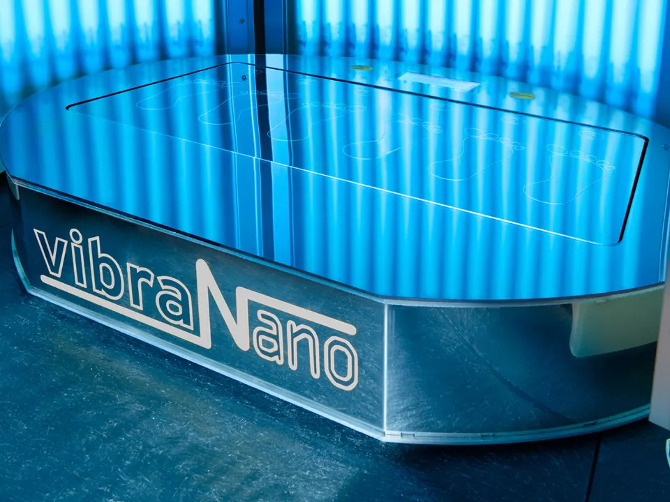 A vibraNano plate on the floor of a megaSun tower, lit by blue tubes
